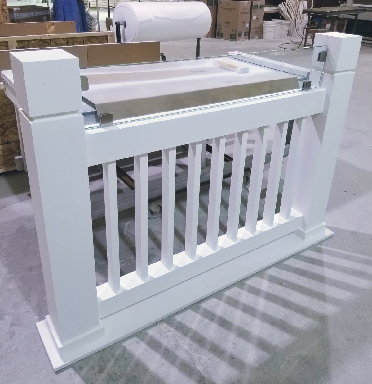 Square-baluster polyurethane porch railing section with newel posts on the Spectis shop floor